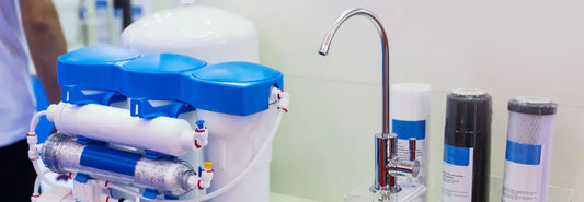 Countertop water purifier on a kitchen bench with a glass of filtered water in a NZ home.