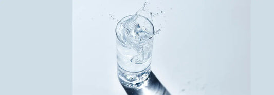 Modern NZ kitchen with reverse osmosis drinking water tap filling a clear glass
